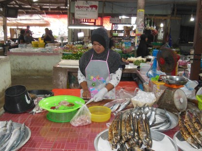 A lady prepares fish